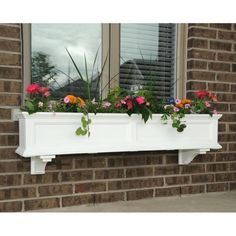 a white window box with flowers in it