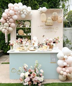 an ice cream stand decorated with balloons, flowers and desserts for a bridal party