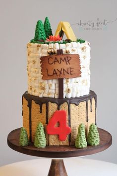 a cake that is sitting on top of a wooden stand with the name camp lane written on it