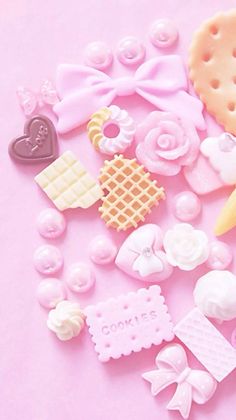 a pink table topped with lots of different types of candies