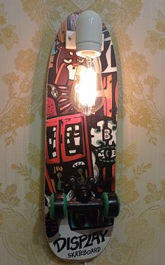 a skateboard mounted to the wall with a light bulb on it's side