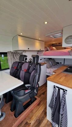 the interior of a camper with bunk beds and desks in place for people to use