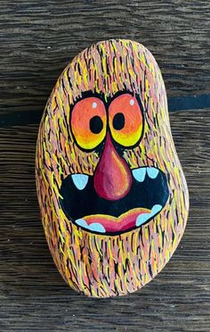 a painted rock with a face on it