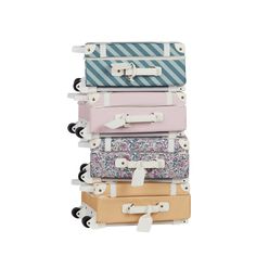 four suitcases stacked on top of each other in different colors and patterns, all with wheels