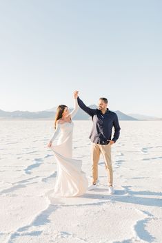 a man and woman dancing in the snow