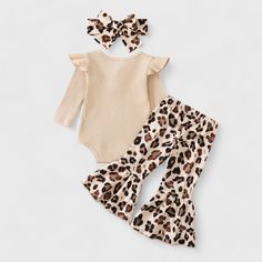 Dress your little fashionista in wild style with our 3-Piece Baby Girl Leopard Flare Pants and Ribbed Bodysuit Set with Headband. This trendy ensemble features stylish flare pants, a cozy ribbed bodysuit, and a matching headband. Available in both leopard and cow print, your baby girl will look adorable and feel comfortable all day long. Cute Fitted Beige Set, Cute Fitted Brown Sets, Leopard Flares, Ribbed Bodysuit, Matching Headband, Dance Teams, Trending Now, Cow Print, Flare Pants