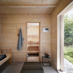 a sauna room with wooden walls and flooring is shown in the foreground