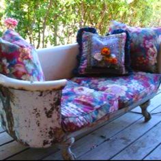 an old couch sitting on top of a wooden deck