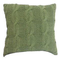 a green knitted pillow on a white background