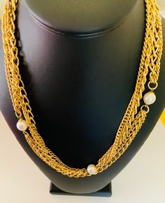 This pretty shiny three layer gold chain necklace is super long and can be worn doubled for a short necklace. It has white creamy pearl accents. The necklace is 48 inches long. This is light weight even though it looks chunky. I specialize in finding fun wearable jewelry please browse my shop for more options. I box all jewelry sales ready to be given as gifts. Elegant Multi-strand Pearl Chain Necklace, Gold Pearl Necklace For Layering, Chic Multi-strand Pearl Chain Necklace, Gold Multi-strand Pearl Necklace For Party, Long Layered Pearl Chain Necklace, Elegant Multi-strand Pearl Charm Chain Necklace, Elegant Multi-strand Chain Necklace With Pearl Charm, Multi-strand Pearl Chain Necklace, Double Strand Gold Chain Necklace With Pearl Charm