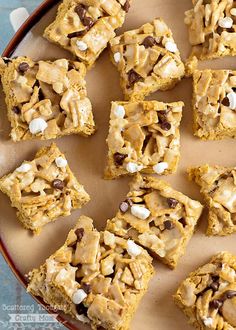 a plate full of cookies and marshmallows on top of each other with chocolate chips