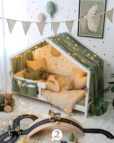 a child's room with a bed and toy train tracks on the floor in front of it