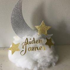 a white cloud with gold stars and the word'aden james'written on it