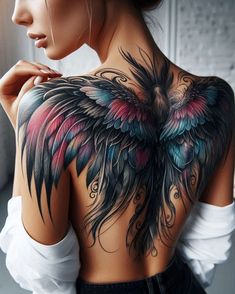 the back of a woman's shoulder with colorful wings on it