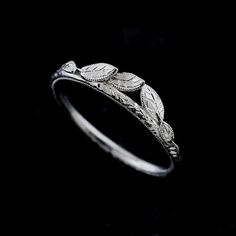 a white gold ring with leaves on it