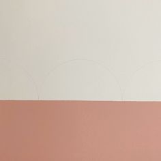 a white and pink wall with circles on it