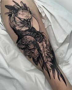 a black and white bird tattoo on the leg