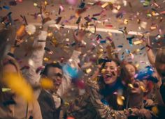 group of people celebrating with confetti and streamers