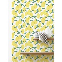 the lemon wallpaper in this kitchen is bright yellow and has green leaves on it