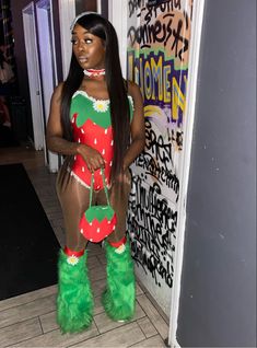 a woman in green furry boots standing next to a wall