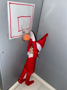 the elf is playing with his basketball hoop