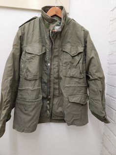 Vintage Military Issued OD Green M65 Field Jacket Size-Small Short Height-63 to 67 inches Chest MN-33 to 37 inches Chest WN-36 to 40 inches Condition-USED in GOOD shape for its age-see pics Made from Cotton/Nylon Dated-1981 NSN# 8415-01-062-0680 Made in the USA! check us out at www.armysurpluswarehouselexington.com Vintage Green Long Sleeve Parka, Green Combat Outerwear For Fall, Short Height, M65 Field Jacket, Extreme Cold Weather, Lexington Ky, Vintage Military, Field Jacket, May 1