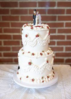 a wedding cake with two people on top