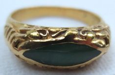 Offering for your consideration is this lovely vintage Chinese jadeite ring. Made of wonderful rich 22K gold. Interior is hallmarked 22K as well as the makers mark. Ring has been tested to ensure the metals purity. It is a size 6 1/4 and has a combined total weight of 4.8 grams. The sides have a Shou symbol which means longevity. Along the top is flowing vines and leaves. It proudly showcases a rich colored piece of Jadeite jade. It is natural A grade and free of any treatments. The eye shaped s Heirloom Gold Jade Ring, Heirloom Jade Ring In Gold, Heirloom Jade Rings In Yellow Gold, Heirloom Yellow Gold Jade Rings, Formal Gold Jade Rings, Victorian Style Gold Emerald Ring For Formal Occasions, Shou Symbol, Jadeite Ring, Pearl Rings Vintage