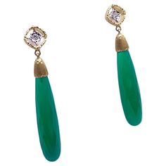 Graceful and with stunning color, these earrings were handmade by a family jeweler outside of Florence, Italy. They are crafted out of solid 18-karat yellow and white gold with a white gold tension back. Each detail is hand carved into the gold; a technique known as Florentine engraving that has been practiced in Italy for over 600 years. The green stones are two briolette-cut green onyx accented by two round, full-cut diamonds atop each earring for a carat weight of .06. The melee grades VS in Sapphire And Diamond Earrings, Green Stones, Diamond Dangle Earrings, Sapphire Earrings, Onyx Stone, Green Onyx, Stunning Earrings, Florence Italy, Modern Earrings