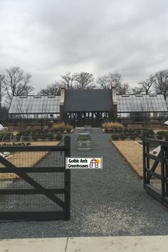 a gated walkway leads to a large house