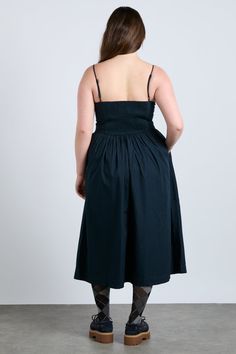 The Penelope apron dress is our navy midi dress featuring a corset style bodice with waist seam details and bows that gather into a fuller skirt. •100% Organic Cotton •Midi dress length •Adjustable straps •Shirred back panel •Select your normal size •Hidden zip detail •Made In India MODEL INFO: Model 1 is 5'9 and is wearing a UK 16. Model 2 is 5'10 and is wearing a UK 10. Navy Midi Dress, Apron Dress, Skirt Co Ord, Cotton Midi Dress, Pink Gingham, Corset Style, Midi Length Dress, Yellow And Brown, Pink Stripes