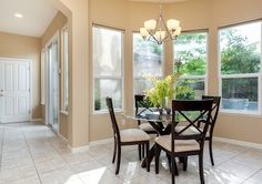 a dining room table with four chairs around it