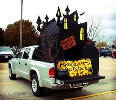 the back end of a pickup truck with an elaborate decoration on it's bed