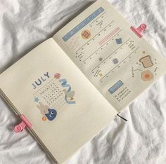 an open planner book with stickers on the pages and writing in pink marker pens