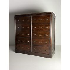 an old wooden cabinet with many drawers