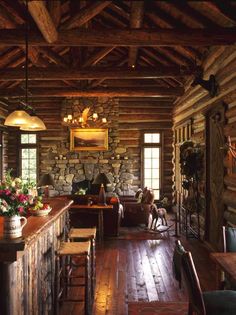 the interior of a log cabin with stone walls