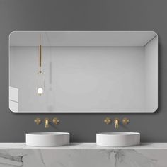 a bathroom with two sinks and a mirror on the wall next to it is shown