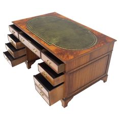 an antique desk with three drawers and a leather top