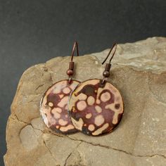 These earrings were created using a kiln firing method. Copper is cut, filed and sanded. Fine glass powder is then layered on the copper and heated the piece with a kiln. These last two steps are repeated many times until the final look is achieved. Each of my products is an original. That's why even the same item can be partly different from the photograph - as for the size, pattern or colour. diameter circle 1 in Artisan Rust-colored Handmade Earrings, Artisan Handmade Rust Earrings, Handmade Artisan Rust Earrings, Earthy Rust-colored Earrings For Gift, Earthy Rust-colored Earrings As Gift, Artisan Brown Earrings With Patina, Artisan Brown Patina Earrings, Artistic Copper Earrings, Earthy Soldered Earrings For Gift