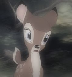 a deer with big eyes standing in the dark