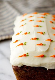 a carrot cake with white frosting on top