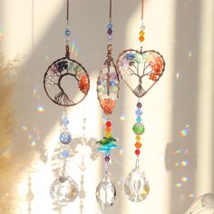 the sun shines brightly through the window and onto an artful wind chime