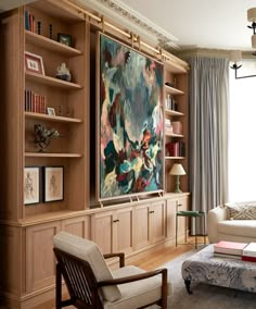 a living room filled with lots of furniture and bookshelves