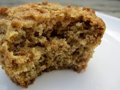 a close up of a muffin on a white plate with a bite taken out