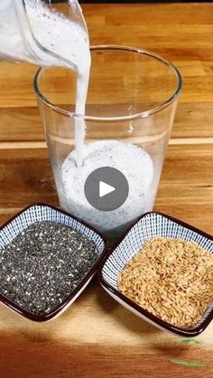 two bowls filled with rice and water on top of a wooden table