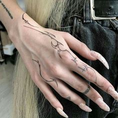 a woman's hand with tattoos on it