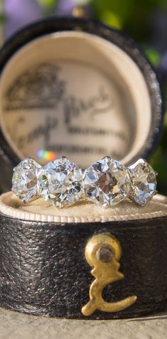 three diamond rings sitting on top of a black box