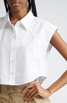 Piping-trimmed raised seams accentuate the unique tailoring of this cropped shirt marked with a flocked Wang-square logo. 19" length (size Medium) Front button closure Point collar Sleeveless, with extended shoulders Curved hem 100% cotton Dry clean Imported Logo Shirts For Women, Cropped Shirt Women, Cropped Short Sleeve Button Up, Tailored Shirts For Women, Shirt Collar Blouse Designs, Cropped Button Up, Summer 2025 Fashion Trends, Interesting Collars, Fashion Tops Blouse Style