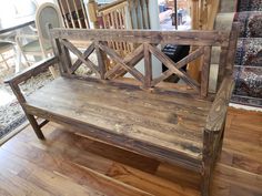 a wooden bench sitting on top of a hard wood floor