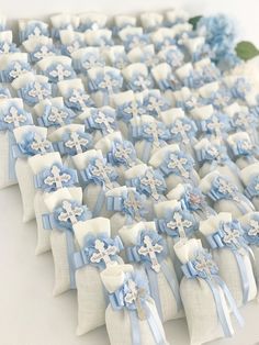 a table topped with lots of blue and white bows